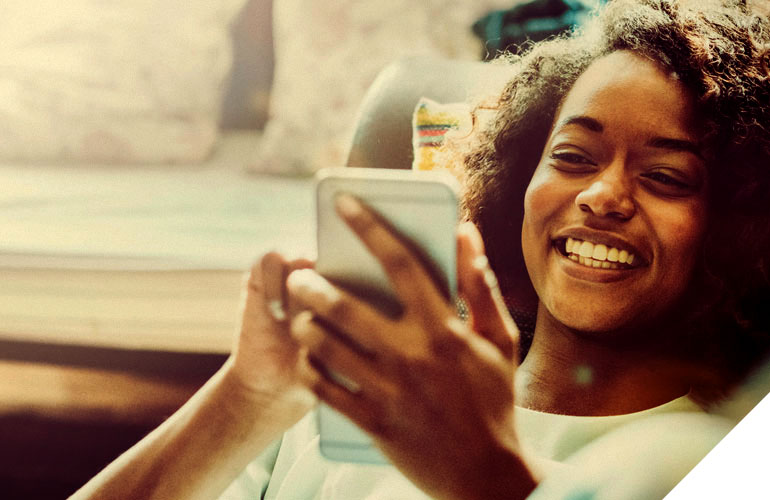 home-future-alt black woman relaxing using her mobile phone
